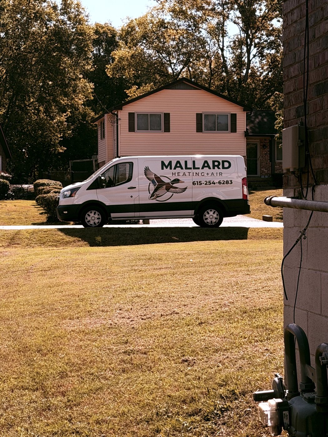 Mallard Heating and Air service van parked outside a home